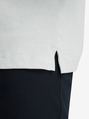 Detail shot of the hem on the blue presence heather comfy cotton blend polo shirt with pocket, emphasizing the bottom edge design