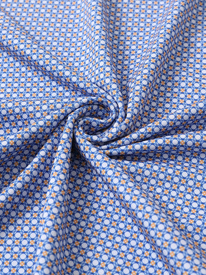 Close-up of white blue circle performance jersey print polo fabric showing breathable texture and vibrant pattern details.
