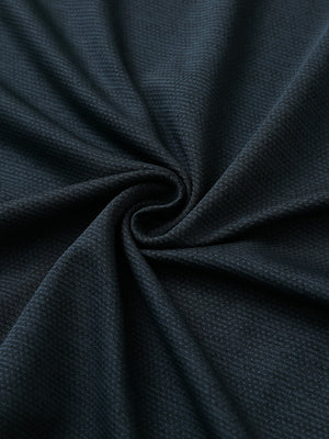 Close-up of jungle green heather ventilated heather jacquard polo fabric showing breathable texture and subtle pattern details.