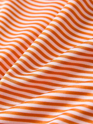Close-up of orange stripe cooling stripe golf shirt fabric showing breathable texture and moisture-wicking stripes.