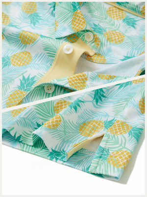 Detail: collar and hem slit of leaves pineapple performance print boys golf polo