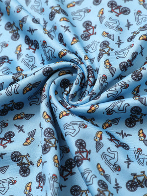Close-up of blue triathlon performance print boys golf polo fabric showing moisture-wicking texture and vibrant pattern.
