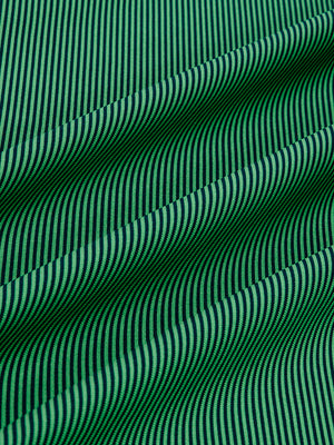 Close-up fabric view of long sleeve pinstripe jersey polo, smooth knit with subtle green stripe stripes