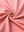 Close-up of peach pink 4 way stretch jacquard polo fabric texture highlighting intricate woven pattern and elasticity.