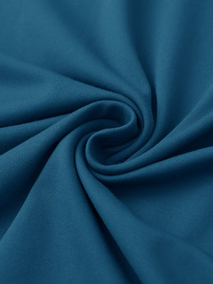 Close-up of fabric on stylish chest print snap polo, showing texture and finish in blue.