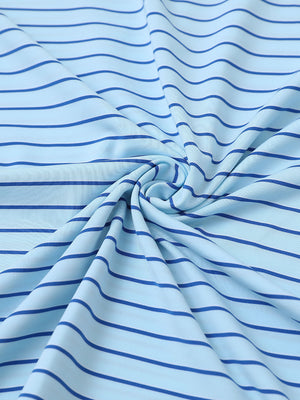 Close-up of light blue/cobalt popular yarn dyed stripe polo fabric showing crisp lines and soft texture.