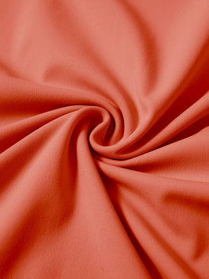 Fabric detail of youth long sleeve hoodied with kangaroo pocket, soft knit texture with orange tone