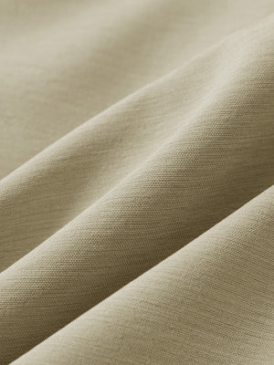 Close-up texture of khaki flat front hybrid golf shorts fabric showing detailed hybrid material and weave.