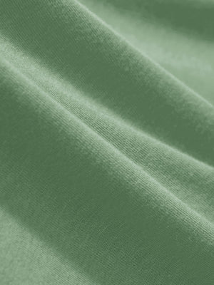 Macro view of the spa green heather comfy cotton blend polo shirt with pocket fabric, showcasing the smooth texture