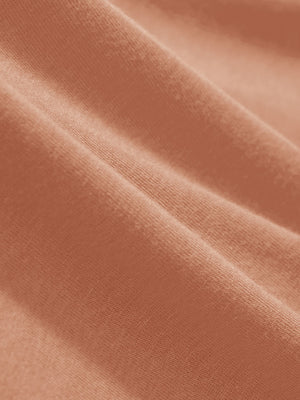 Macro view of the orange adobe heather comfy cotton blend polo shirt with pocket fabric, showcasing the smooth texture