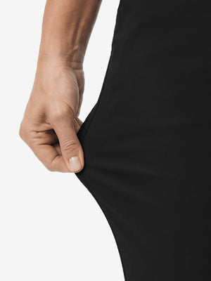 Detail view of stretch fabric on black women's regular fit stretchy golf pants