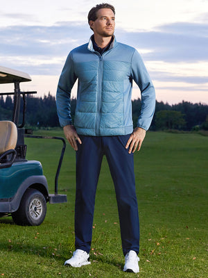 Model posing with hands on hips on course, wearing golf fleece winter puffer jackets in shadow blue