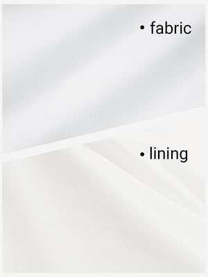 Close-up texture of white women's gym golf shorts with liner pocket fabric showing detailed outer and inner lining material.