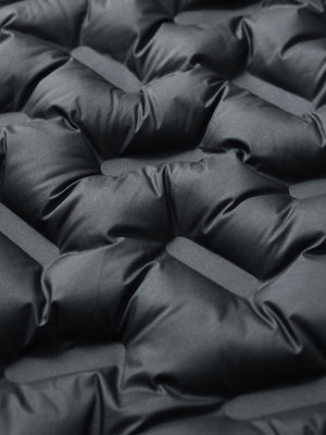 Fabric close-up showing the material of black boys full-zip fleece-lined puffer vest.