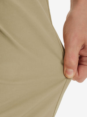 Action shot demonstrating the stretch of the khaki youth water resistant cotton blend golf pants for active movement