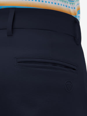 Close-up of the back pocket detail on the navy youth water resistant cotton blend golf pants, emphasizing storage