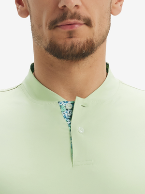 Close-up of model in light green moisture-wicking short sleeve henley shirt, nose to chest front view.